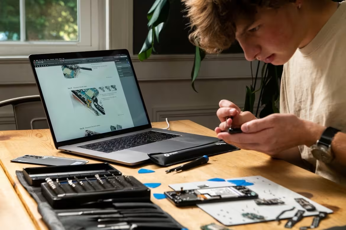 Technician repairing a phone with tools